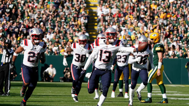 New England Patriots CB Jack Jones (13) returns an interception against the Green Bay Packers